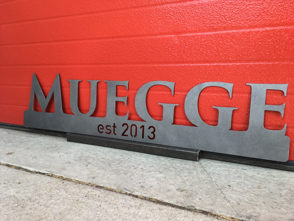 Metal family name sign with "Muegge est 2002" engraved.