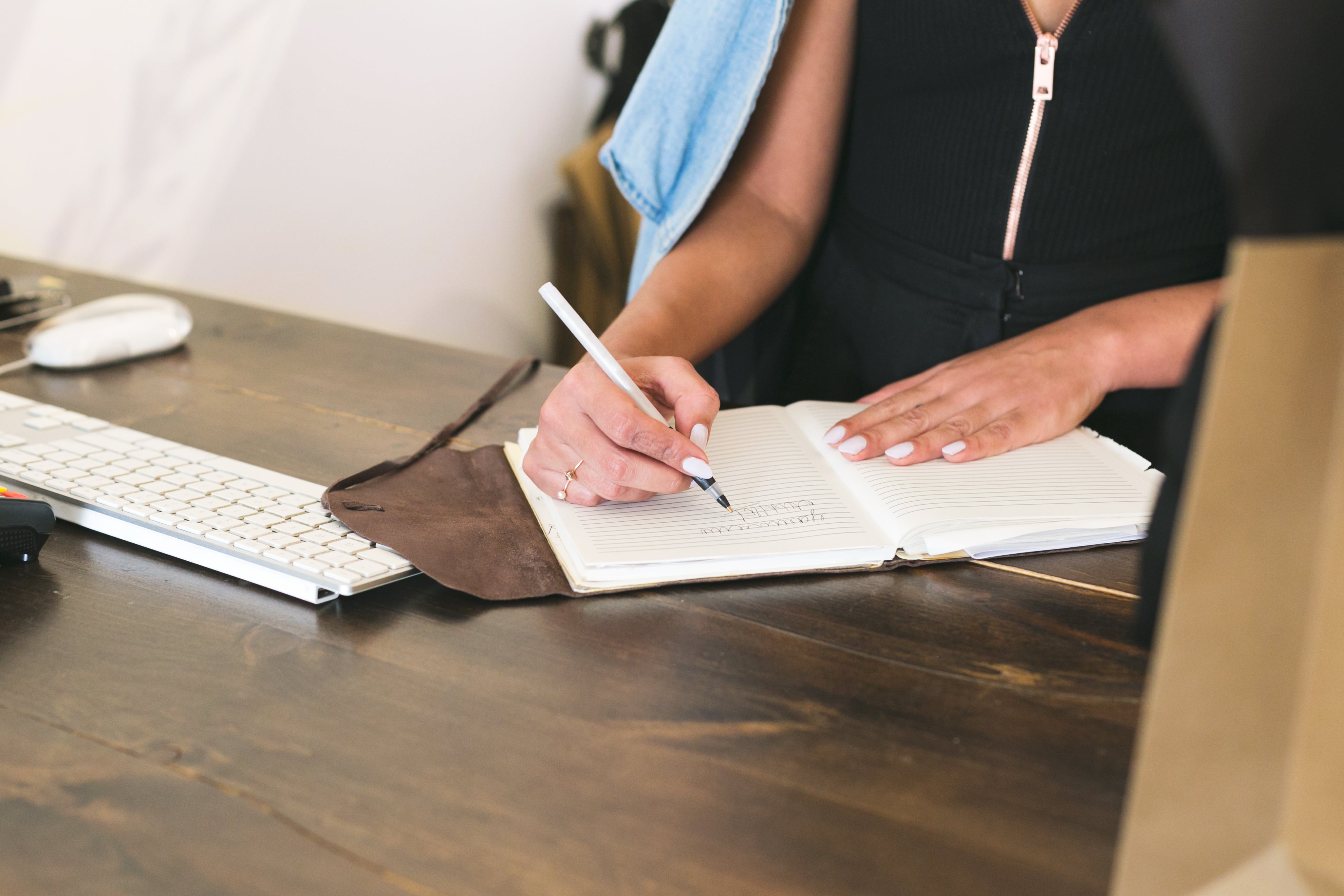 An entrepreneur taking notes for her small business.