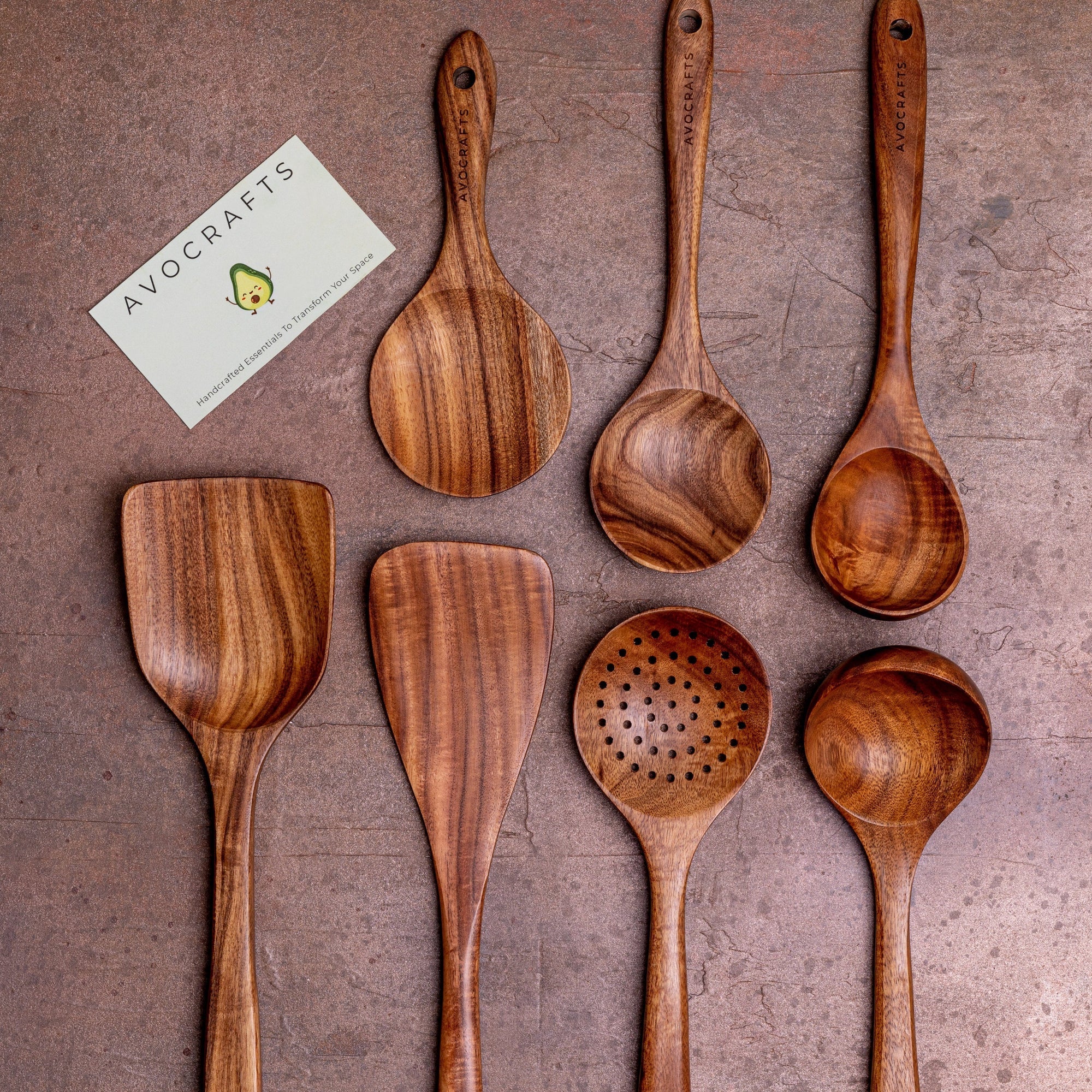 Set of seven wooden kitchen utensils displayed on a brown surface with product details and price.