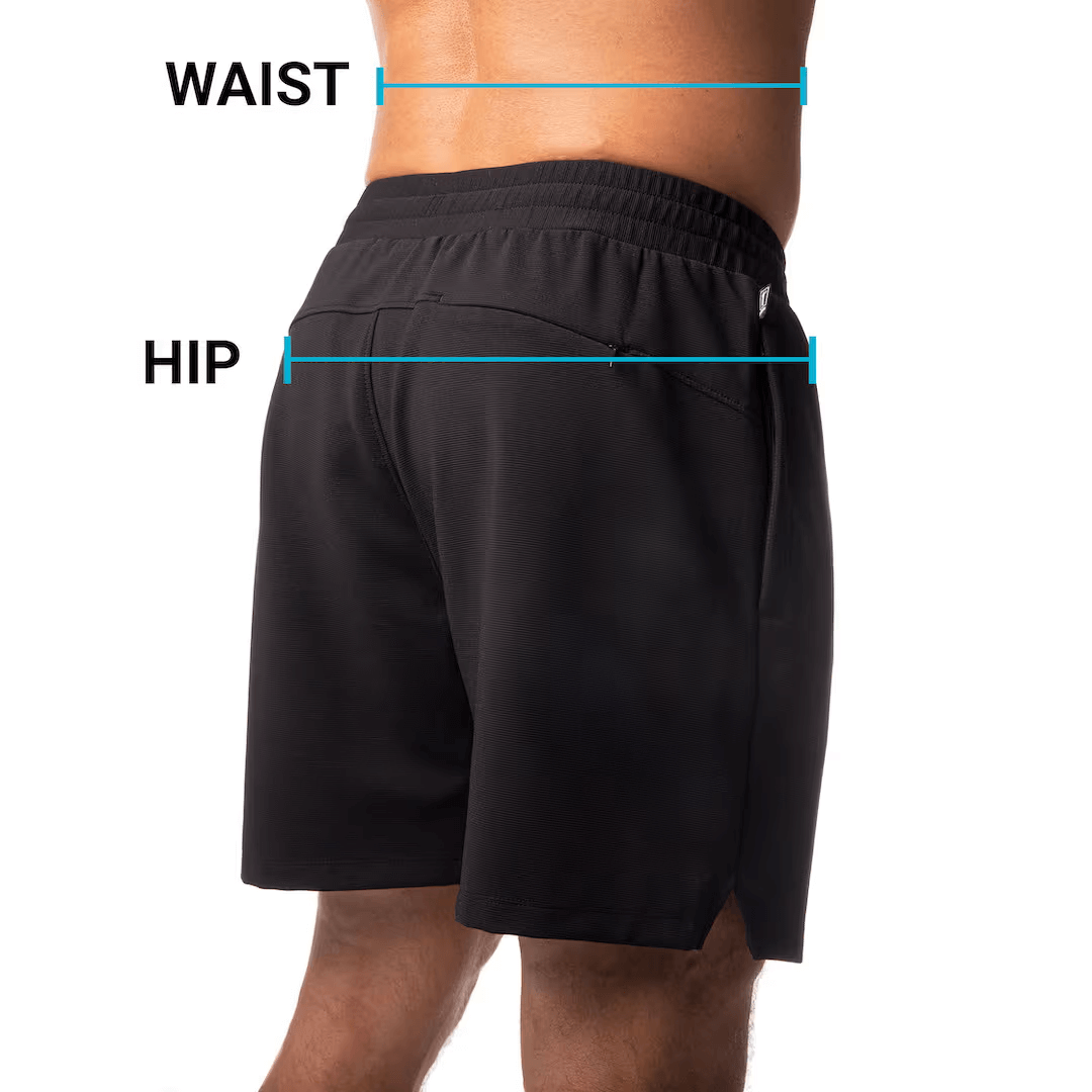 Rear view of a person wearing black shorts with waist and hip measurements indicated.