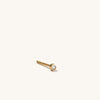 Single Tiny Diamond Stud: A close-up of a 14k gold stud earring with a small, white diamond, handcrafted and ethically sourced. Sold individually.