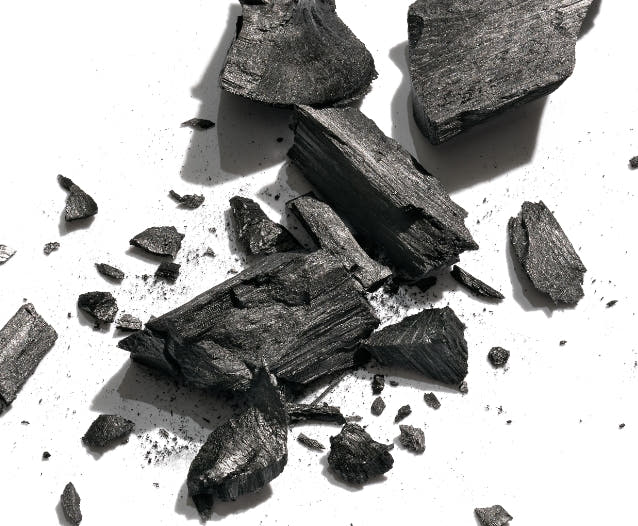 Crushed black charcoal on a white background. 