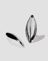 Puffy Dagger earrings on grey background.